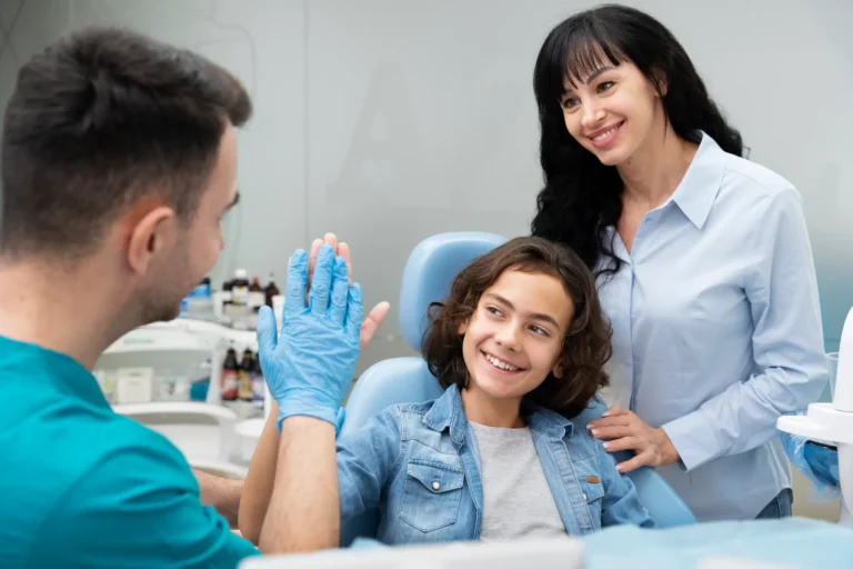 A smiling family dentist with patients in a dental clinic.
